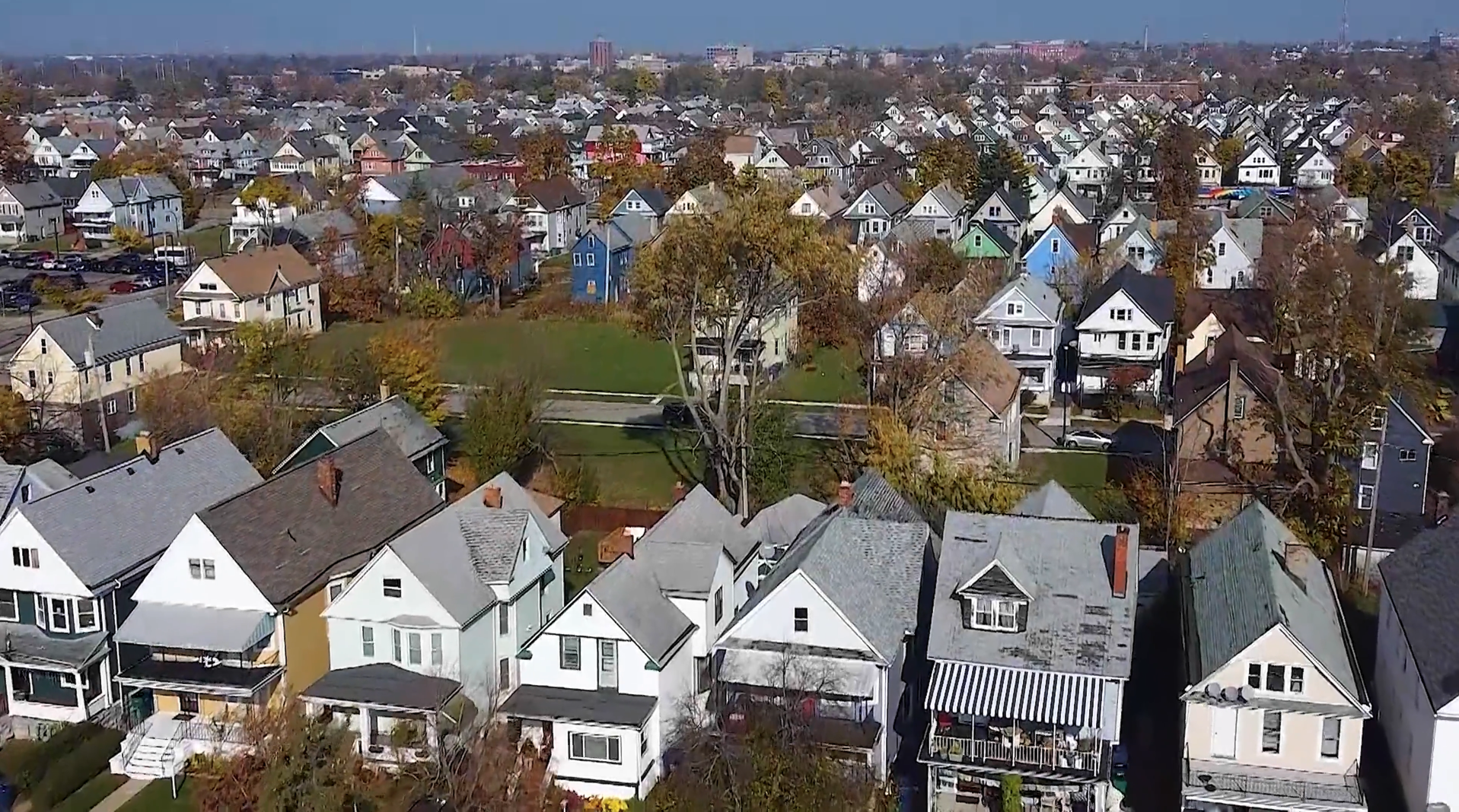 aerial view of houses and trees in a neighborhood